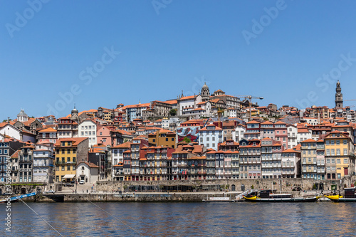 Colorful houses of Porto Ribeira, traditional facades, old multi-colored houses with red roof tiles on the embankment in the city of Porto, Portugal. Unesco World Heritage.