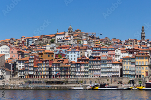 Colorful houses of Porto Ribeira, traditional facades, old multi-colored houses with red roof tiles on the embankment in the city of Porto, Portugal. Unesco World Heritage. © An Instant of Time