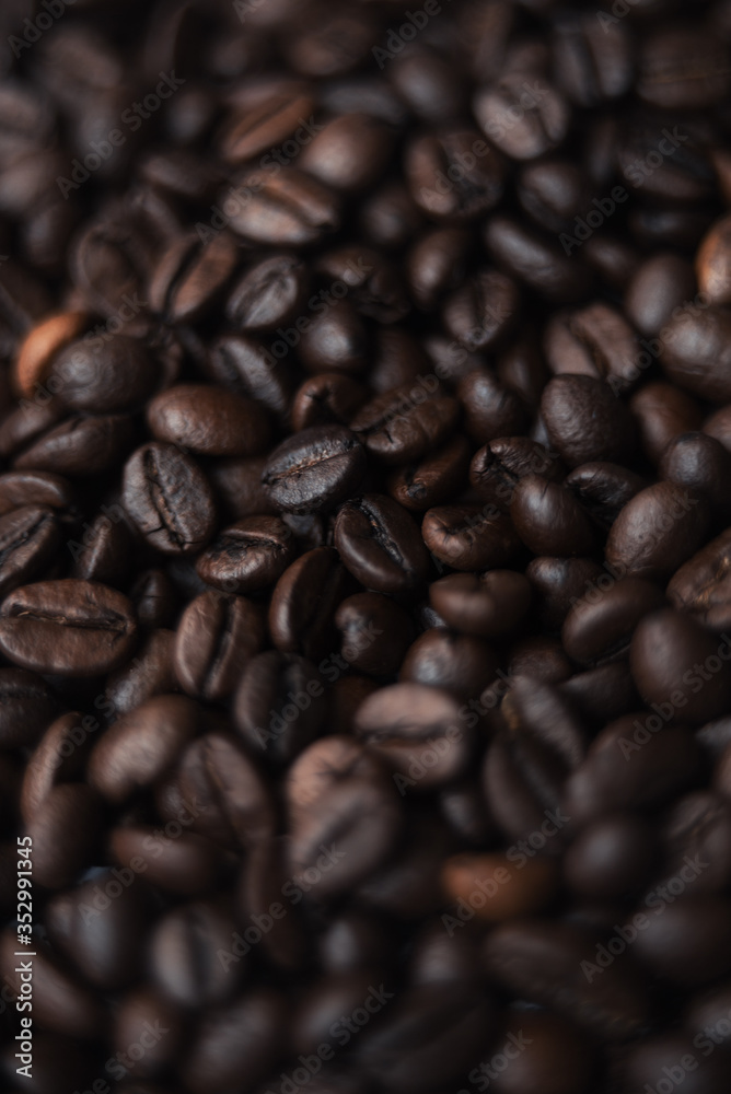 Coffee beans in blur with focuses in the middle. background for the desktop in the coffee industry, top view. dark roasted coffee. Coffee beans in blur with focuses in the middle. background for the desktop in the coffee industry, top view. dark roasted coffee.