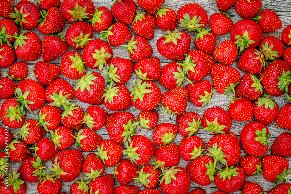 Fresh German strawberries in carton paper boxes on wooden table, top view. Red strawberry berrees harvesting concept Fresh German strawberries in carton paper boxes on wooden table, top view. Red strawberry berrees harvesting concept