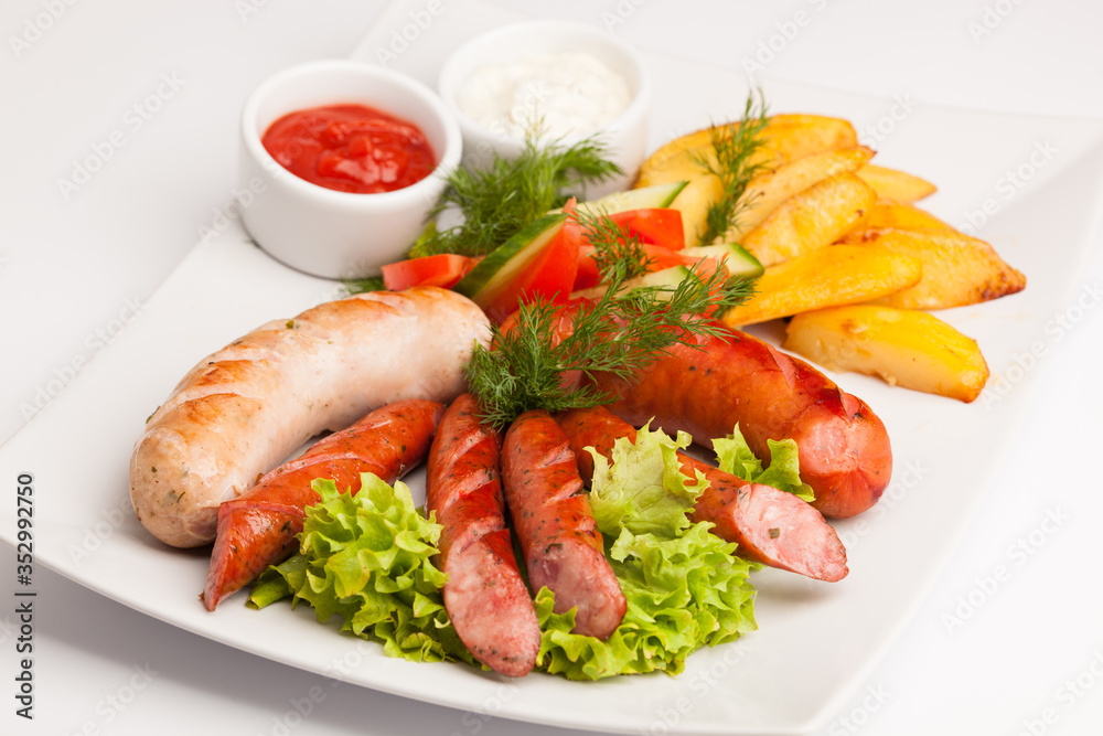 beautiful photo close-up menu of potatoes, sausage salad on a plate on a white background beautiful photo close-up menu of potatoes, sausage salad on a plate on a white background