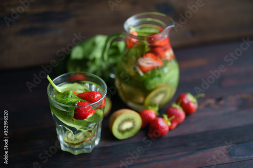 Summer refreshing strawberry and kiwi lemonade. Vitamin drink. Homemade infused water with fresh fruits and berries. Tasty cold seasonal beverage