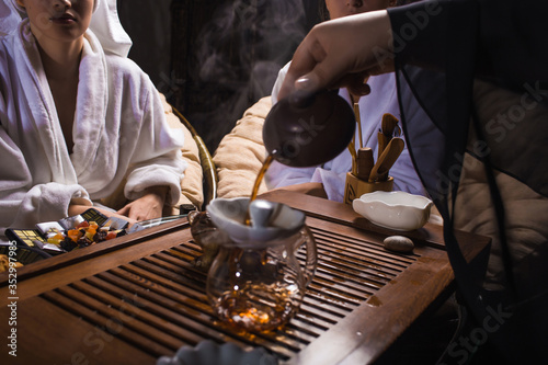 Tea ceremony after the sauna. Girls in white coats drink Chinese tea