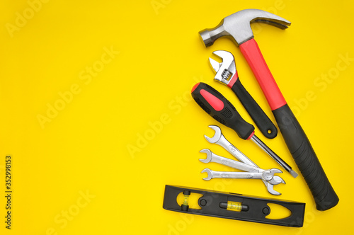 Group of tools on yellow background photo
