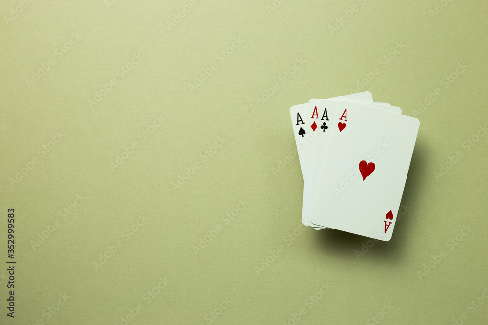 Four aces cards on khaki green background. top view, copy space Four aces cards on khaki green background. top view, copy space