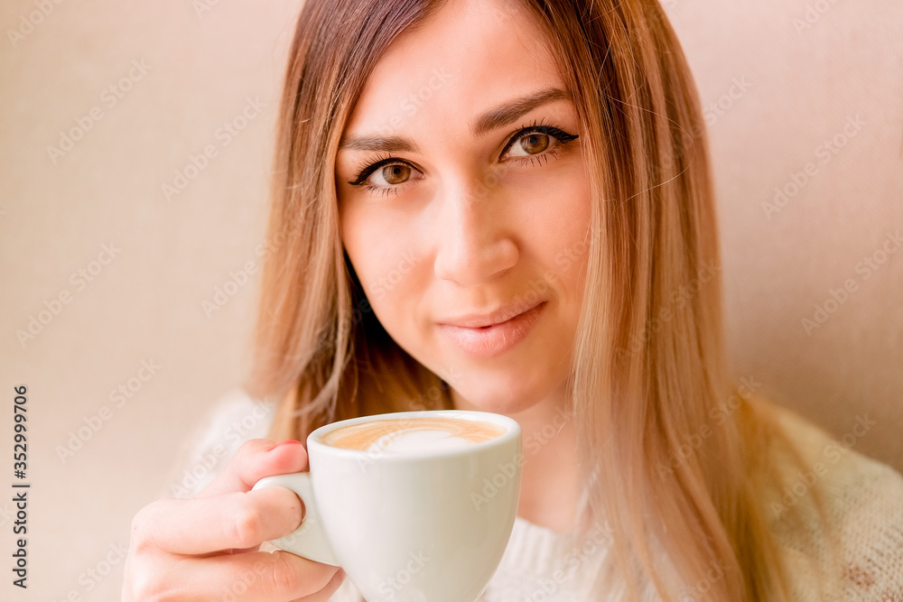 beautiful sexy blonde holds a cup of coffee. girl enjoys a delicious drink, morning ritual. beautiful sexy blonde holds a cup of coffee. girl enjoys a delicious drink, morning ritual.