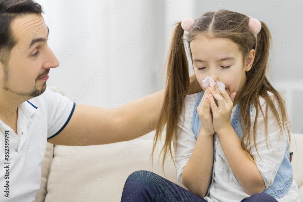Daughter wiping nose with handkerchief. Sick daughter. Daughter wiping nose with handkerchief. Sick daughter.