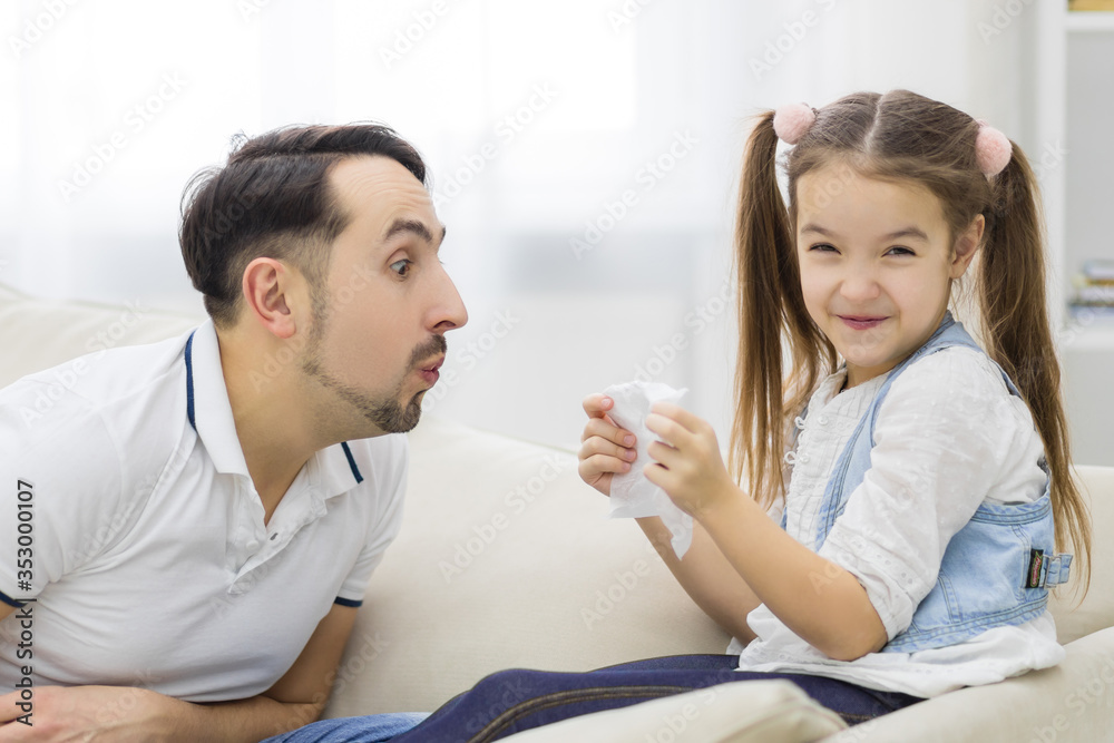 Father and his daughter are playing at home. Father and his daughter are playing at home.