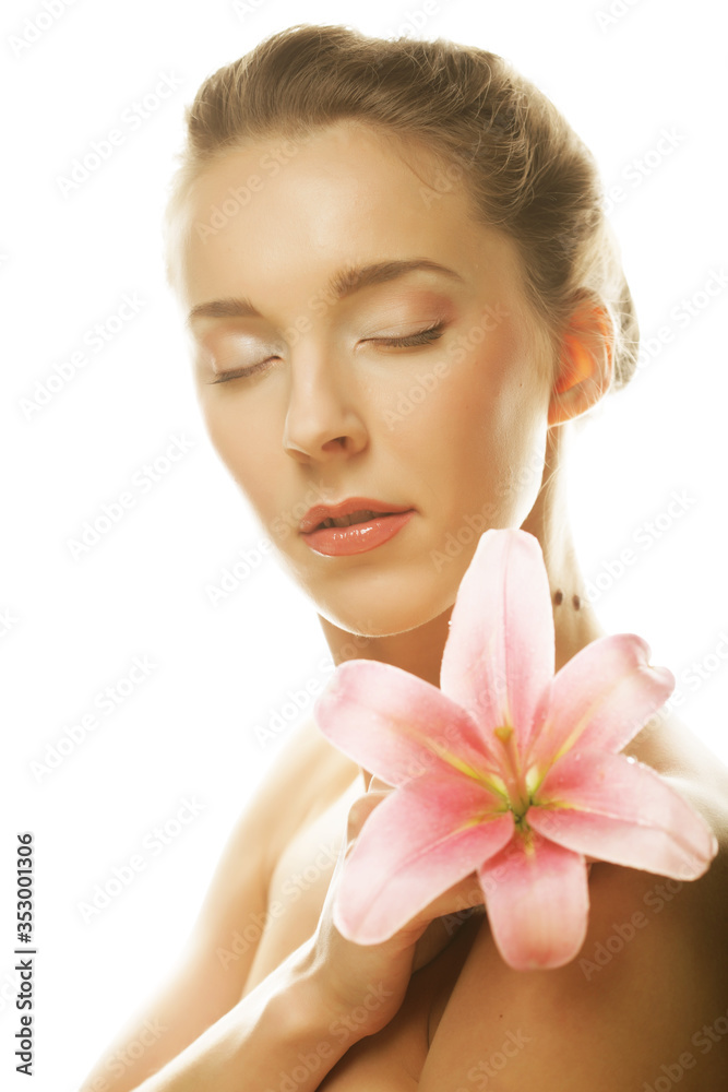 Beauty face of the young woman with pink lily Beauty face of the young woman with pink lily