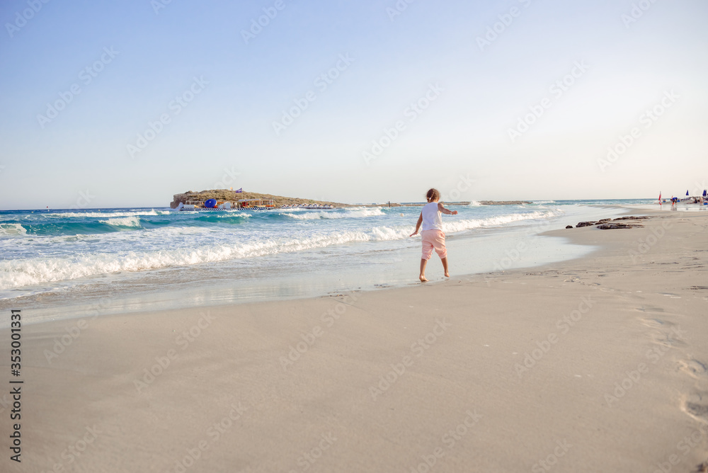 happy  little girl have fun and joy time at beautiful beach