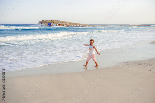 happy  little girl have fun and joy time at beautiful beach