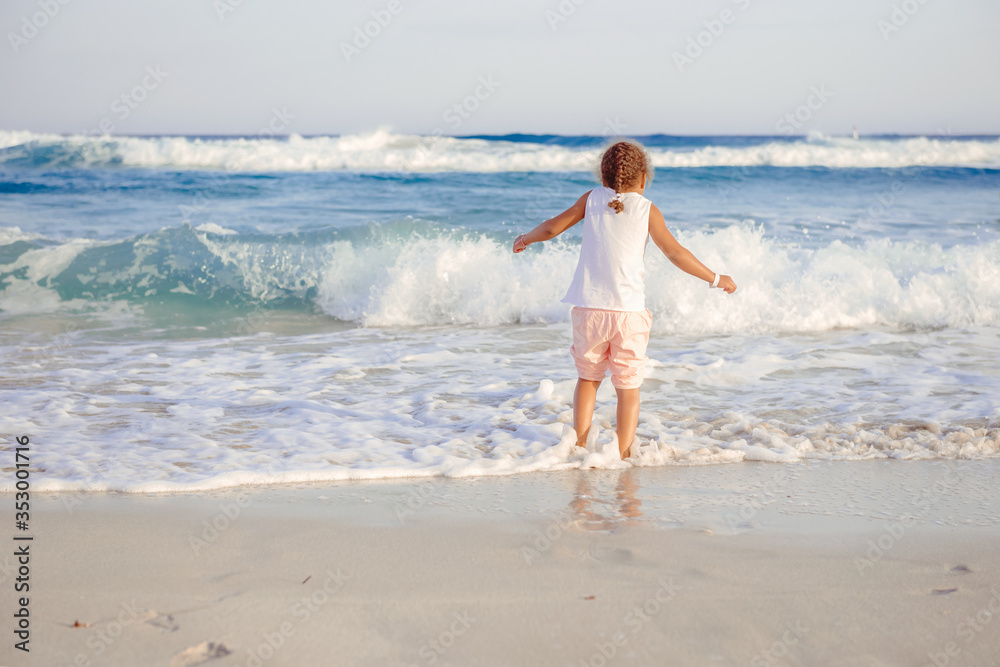 happy little girl have fun and joy time at beautiful beach happy little girl have fun and joy time at beautiful beach