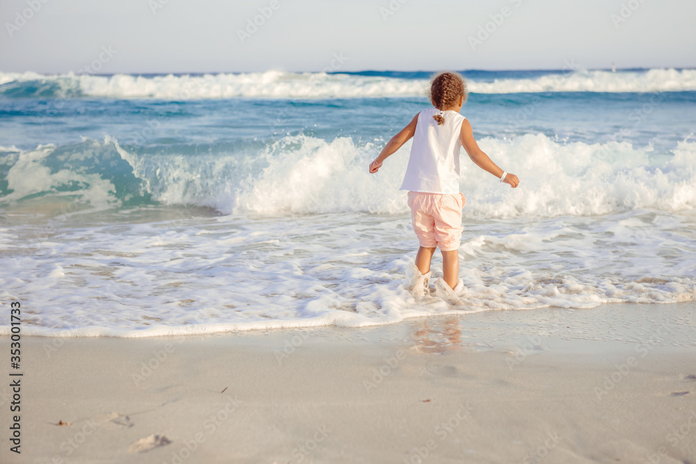 happy little girl have fun and joy time at beautiful beach happy little girl have fun and joy time at beautiful beach