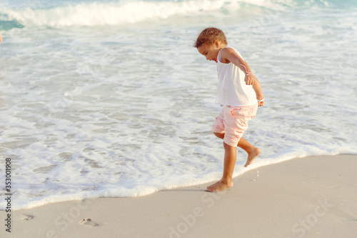 happy little girl have fun and joy time at beautiful beach