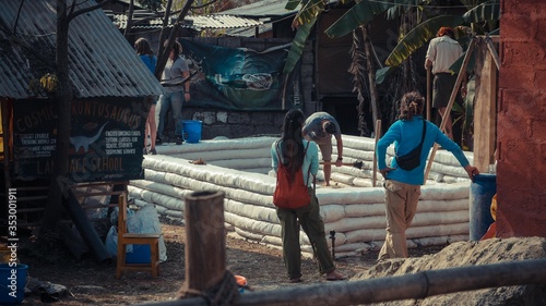 Woman and men standing by stack of white walls