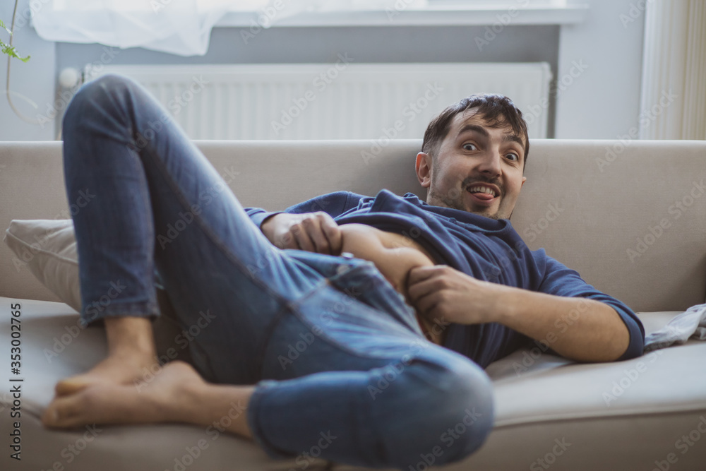 A man suffering from hangover and laying on sofa. A man suffering from hangover and laying on sofa.