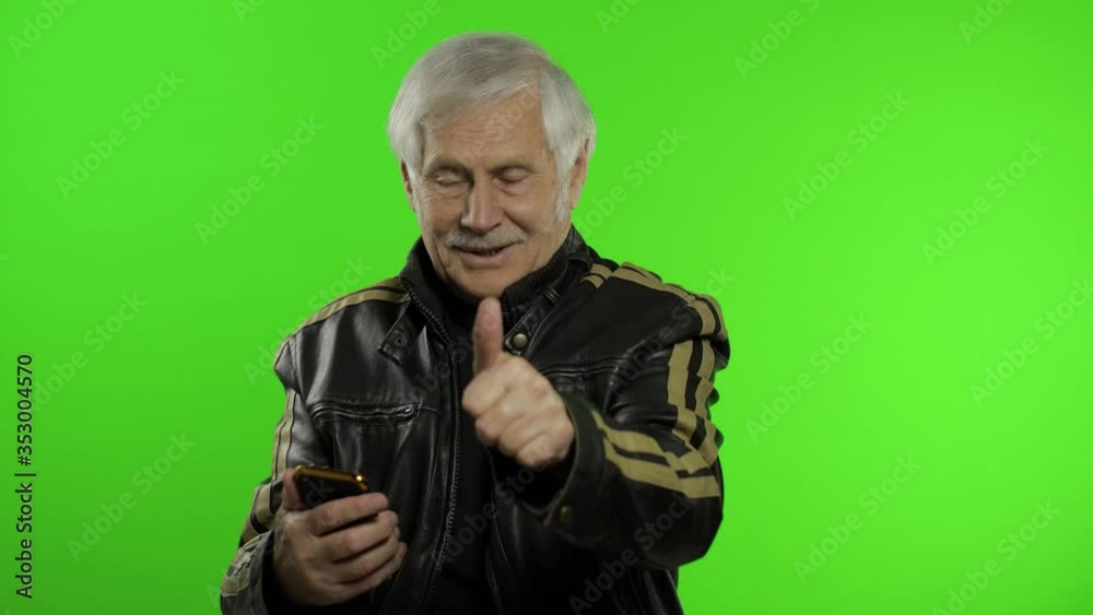 Elderly stylish caucasian grandfather man using smartphone for online shopping