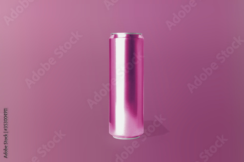 Aluminum can with drink on pink background