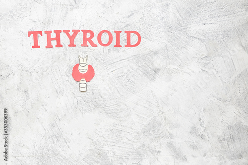 Word THYROID with drawing on white background photo