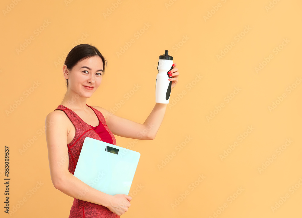 Young woman with weight scales and bottle of water on color background Young woman with weight scales and bottle of water on color background