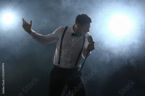Handsome man singing on stage