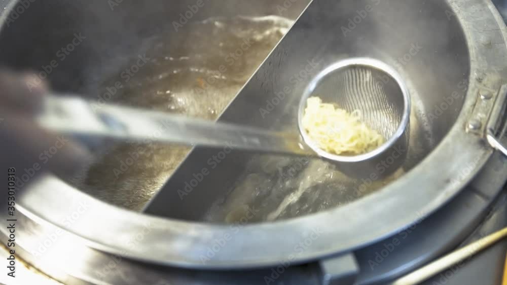 Chinese style dumplings being cooked in a boiling pot Chinese style dumplings being cooked in a boiling pot