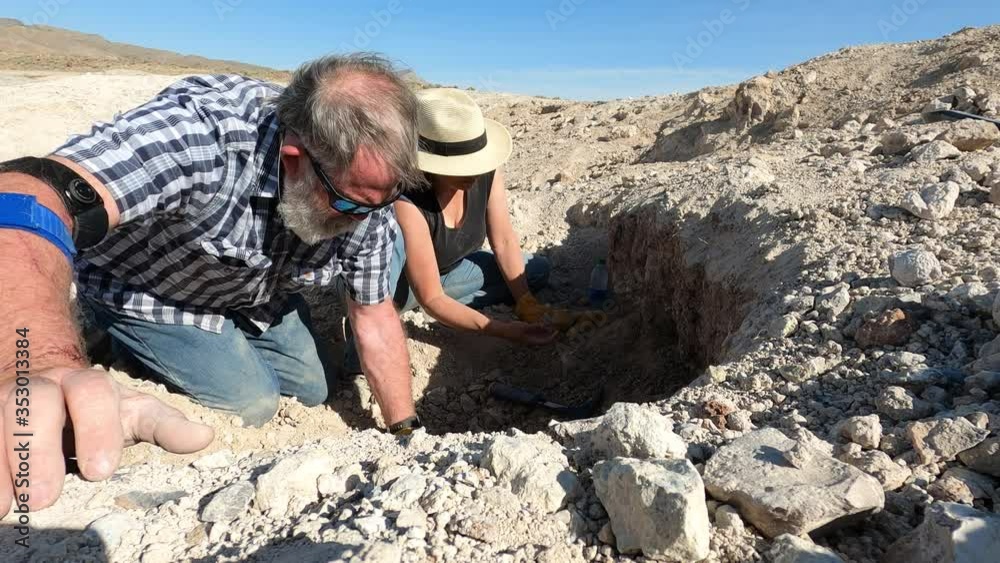 Couple rockhounding digging geodes Utah desert fast motion. Digging and