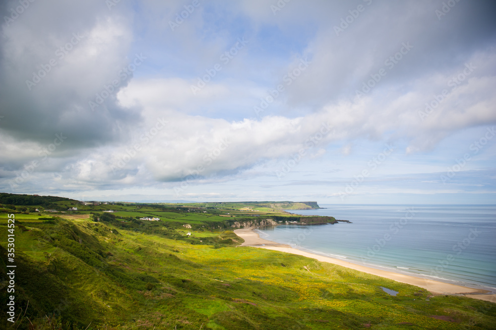 Costal view near Ballitoy, County Atrim, Northern Ireland. Beautiful green landscape with cliffs and sandy beaches. Costal view near Ballitoy, County Atrim, Northern Ireland. Beautiful green landscape with cliffs and sandy beaches.