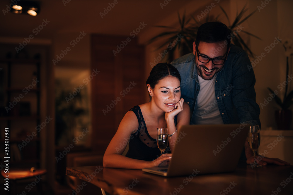 Portrait of a couple relaxing at home, using laptop. Portrait of a couple relaxing at home, using laptop.