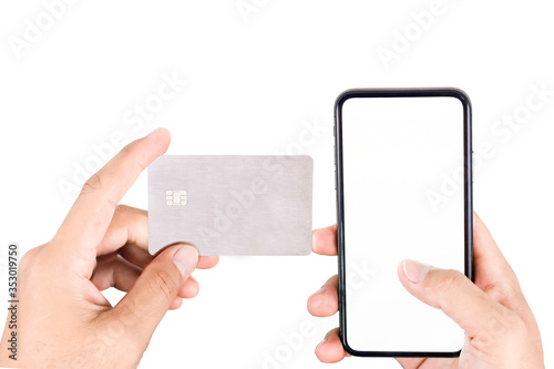 The hands of an Asian man holding a credit card and using phone payments to make online purchases with a credit card in a phone application or home stay website and buying products online.