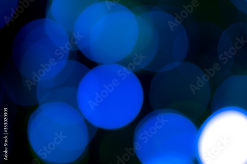 Natural blue bokeh, soft color tone, black surface.