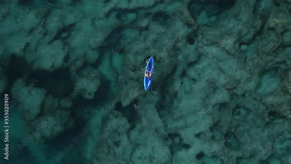Overhead Shot Of Kayak Paddling Over Crystal Clear Ocean Water, Lebanon, top view tracking Overhead Shot Of Kayak Paddling Over Crystal Clear Ocean Water, Lebanon, top view tracking