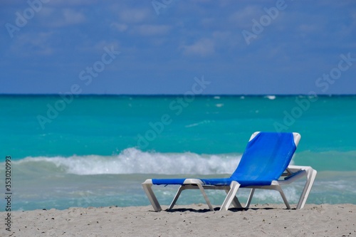 lounge chairs on a tropical beach