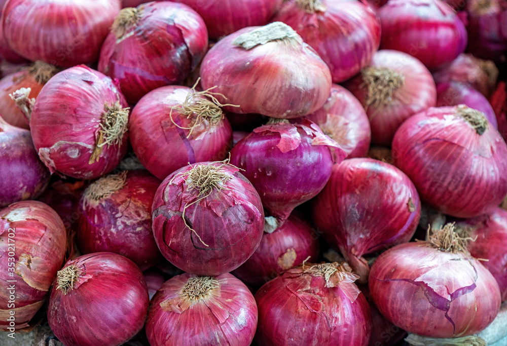 A pile of Red Onions (Allium cepa) on a local vegetable market in Arequipa, Peru. A pile of Red Onions (Allium cepa) on a local vegetable market in Arequipa, Peru.