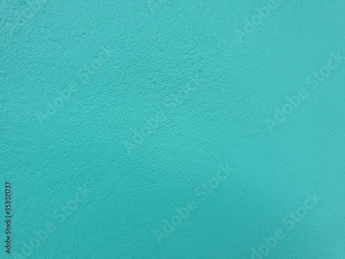 Green-blue concrete wall and background. The combination of green and blue creates strange colors.Turquoise painted texture with abstract 

