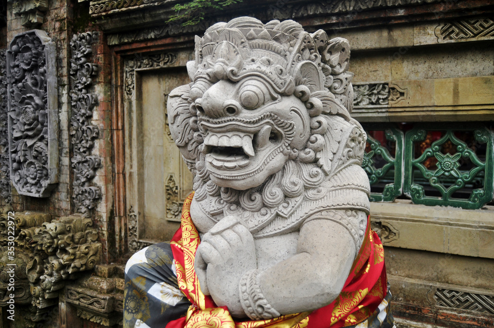 Art sculpture and carved antique deity angel god of hindu statue balinese style in Ubud Palace or Puri Saren Agung historical building complex situated at Gianyar Regency in Bali, Indonesia