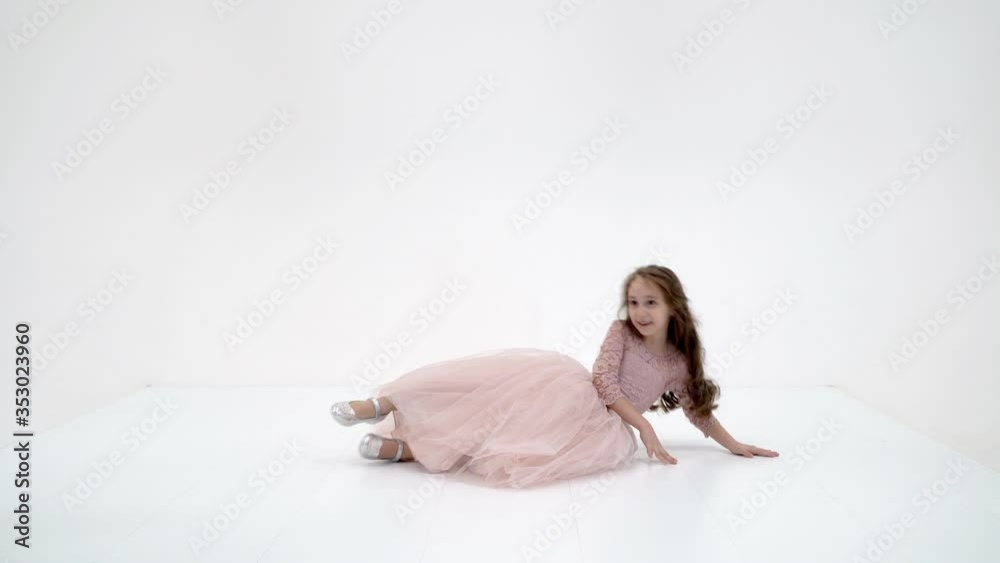 Pretty Girl in Fashionable Dress Standing and Smiling at Camera Pretty Girl in Fashionable Dress Standing and Smiling at Camera