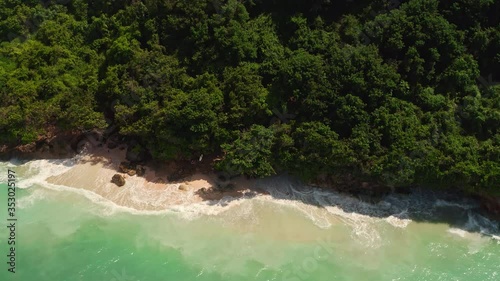 Wallpaper Mural Aerial view from above on a tropical island and ocean waves crashing and foaming against sand beach. Bird's eye aerial shot of golden beach meeting deep blue ocean water. Tourism concept after covid. Torontodigital.ca