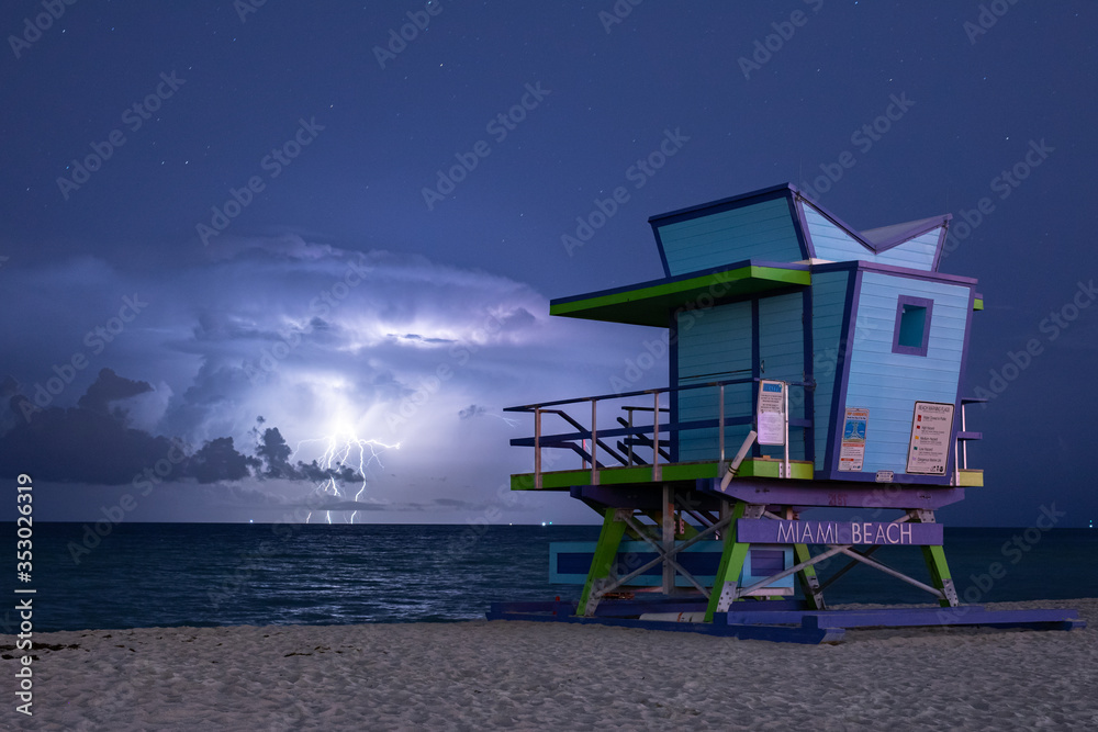 Miami Beach, Florida - Lightning storm at night over a lifeguard tower Miami Beach, Florida - Lightning storm at night over a lifeguard tower