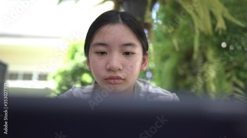 Teen girl uses digital tablet learning online