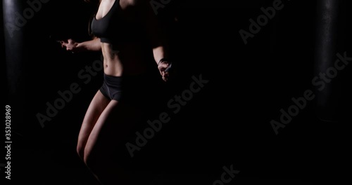 Boxing concept. Fitness woman training jump exercise on skipping rope. Sport woman practicing jumping with skipping rope in slow motion. Close up fit girl using jump rope for cardio training. 4k