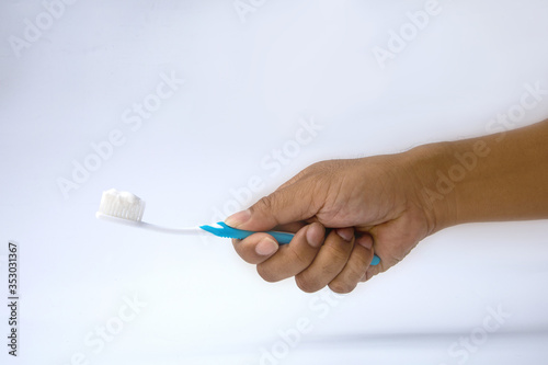 Man hands are holding toothbrush. Dark background