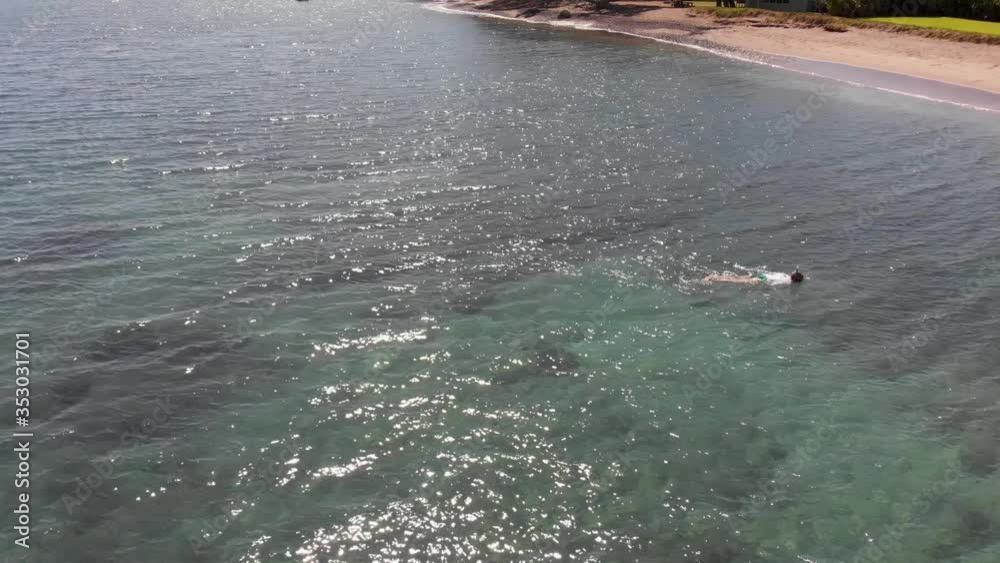 Two swimmers snorkel in the clear warm waters of Olowalu Beach on Maui, Hawaii. Two swimmers snorkel in the clear warm waters of Olowalu Beach on Maui, Hawaii.