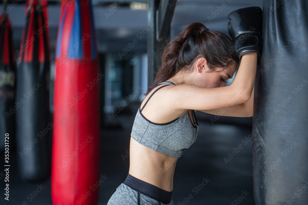 Fitness girl leaned on punching bag and boxing is good workout .5