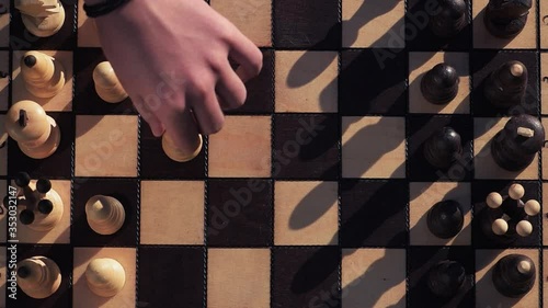 chess game close-up, players make the first moves in the game, top view