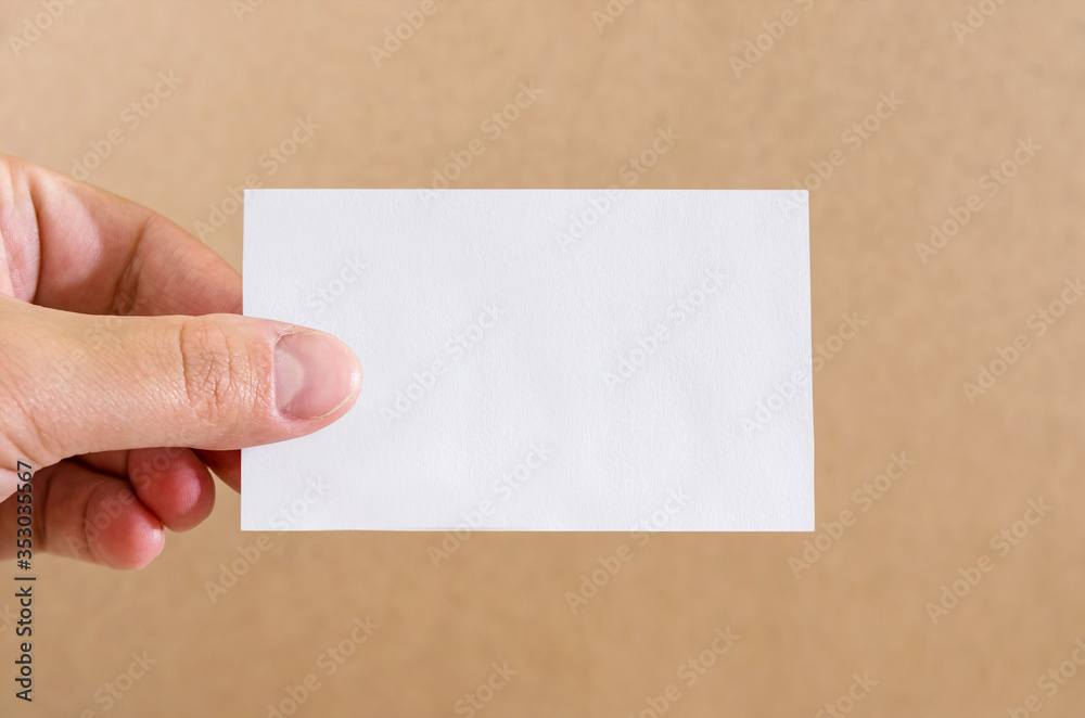 empty piece of paper in a female hand. White card in a hand. Close-up. Copy space. Place for text. empty piece of paper in a female hand. White card in a hand. Close-up. Copy space. Place for text.