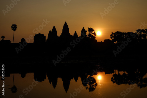 Beautiful view of the silhouette Angkor wat and its reflection in the lake at sunrise