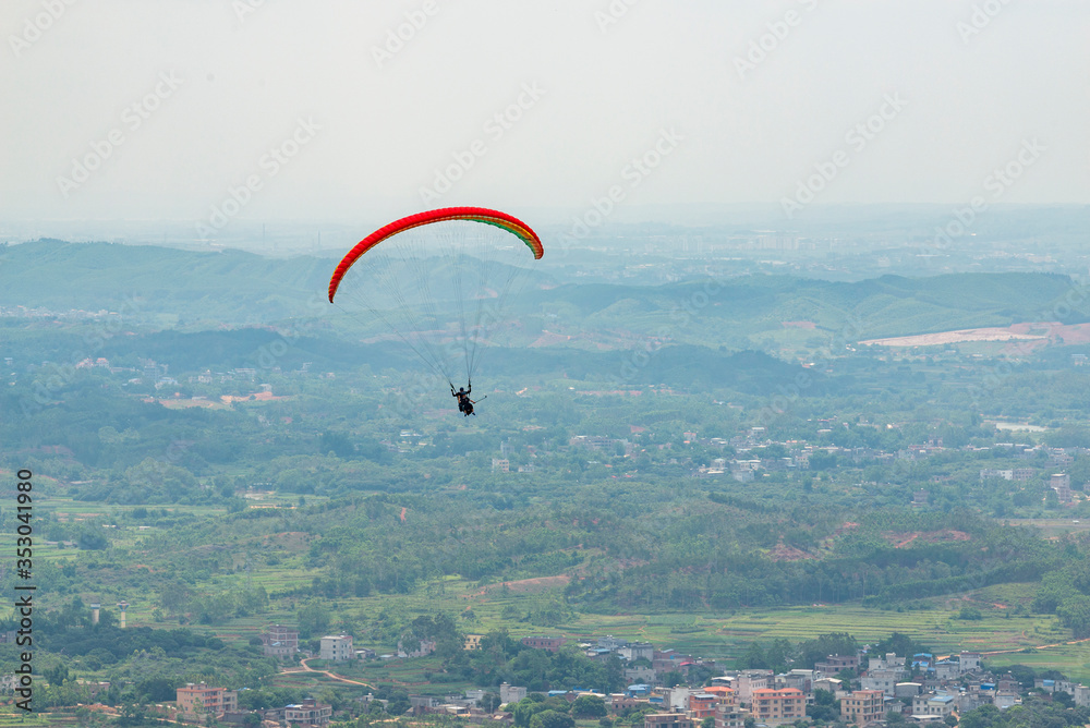 Outdoor city green hill scenery and paragliding Outdoor city green hill scenery and paragliding