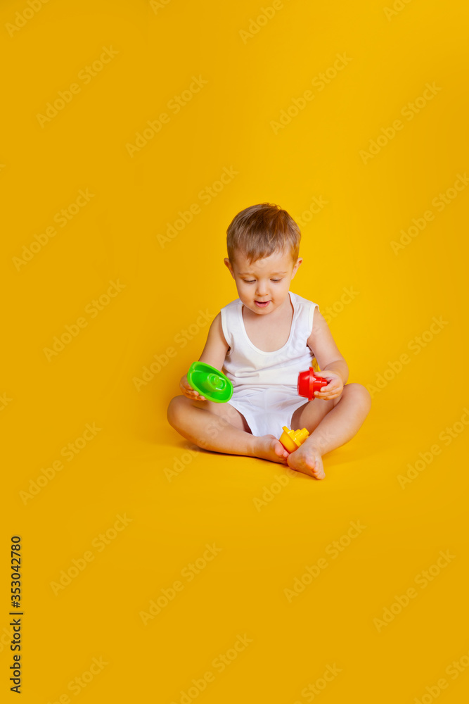 a little boy sits and tries to connect the details from an educational game such as a pyramid a little boy sits and tries to connect the details from an educational game such as a pyramid