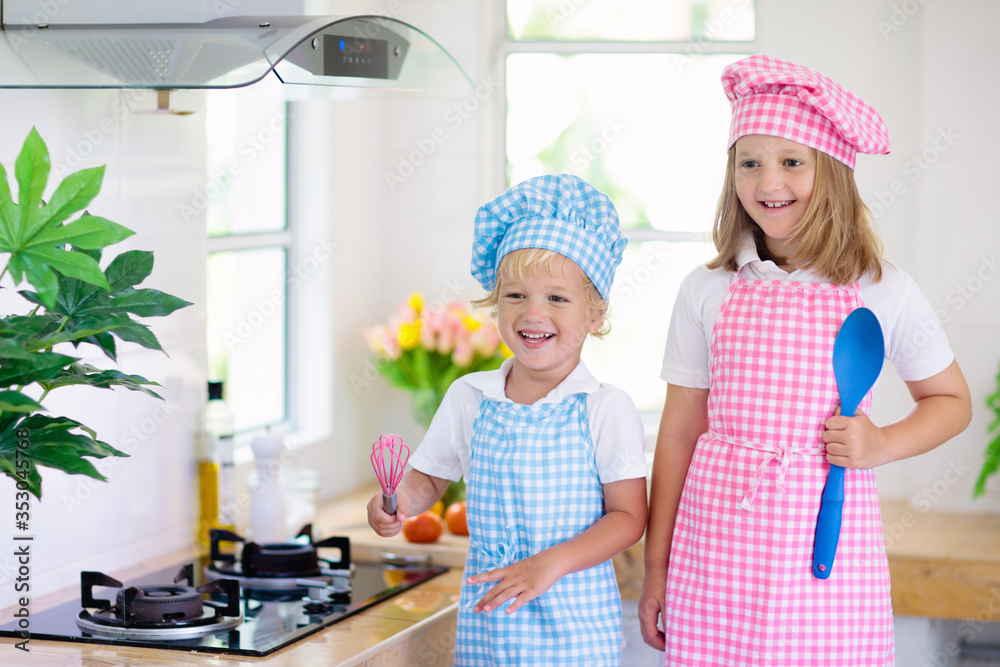 Kids cook in white kitchen. Children cooking. Kids cook in white kitchen. Children cooking.